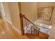 Ornate staircase with hardwood steps, decorative wrought iron railing and landing at 17509 Ohara Dr, Port Charlotte, FL 33948