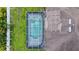 Overhead view of screened-in pool, roof, and surrounding landscaping at 1762 Mincey Ter, North Port, FL 34286