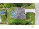 Overhead view of a home, driveway, screened in pool and surrounding lawn at 1762 Mincey Ter, North Port, FL 34286