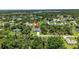 This is an aerial shot showcasing a house nestled amidst trees in a peaceful neighborhood, with a screened pool at 1762 Mincey Ter, North Port, FL 34286