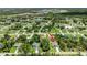 This is an aerial view of a cozy home nestled among green trees in a peaceful neighborhood with convenient road access at 1762 Mincey Ter, North Port, FL 34286