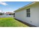Home backyard with green grass and a partial view of the screened-in lanai at 1762 Mincey Ter, North Port, FL 34286