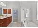Bathroom featuring a soaking tub, double vanity with wood cabinets, and modern lighting fixtures at 1762 Mincey Ter, North Port, FL 34286