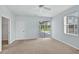 A well-lit bedroom with access to the pool, a closet, and a neutral carpet at 1762 Mincey Ter, North Port, FL 34286