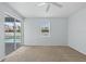 Light-filled bedroom with sliding glass doors and a window overlooking the pool area and a neutral carpet at 1762 Mincey Ter, North Port, FL 34286