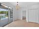 Dining area with sliding doors leading to the pool and an elegant chandelier at 1762 Mincey Ter, North Port, FL 34286