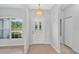 Bright entryway features a decorative chandelier and white door with arched windows for natural light at 1762 Mincey Ter, North Port, FL 34286