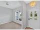 Bright entryway features a decorative chandelier and white door with arched windows for natural light at 1762 Mincey Ter, North Port, FL 34286