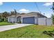 Well-maintained single-story home with a two-car garage and a lush green lawn at 1762 Mincey Ter, North Port, FL 34286