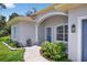 Inviting front entrance with manicured landscaping and a charming blue front door at 1762 Mincey Ter, North Port, FL 34286