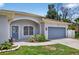 Charming single-story home with a neatly landscaped yard and blue garage door at 1762 Mincey Ter, North Port, FL 34286