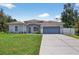 Charming single-story home with a well-manicured lawn and two car garage at 1762 Mincey Ter, North Port, FL 34286