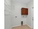 Functional laundry room featuring overhead shelving and cabinet space for efficient organization at 1762 Mincey Ter, North Port, FL 34286