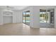 Spacious living area featuring tile flooring and sliding glass doors to the pool area at 1762 Mincey Ter, North Port, FL 34286