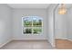 This living room is bright and spacious, featuring a large window and tiled floors for easy cleaning at 1762 Mincey Ter, North Port, FL 34286