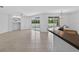 Open-concept living area with bar seating and a sliding glass door to the pool area at 1762 Mincey Ter, North Port, FL 34286