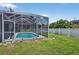 This is a serene screened-in pool area blending relaxation with tropical vibes, set against a backdrop of lush greenery at 1762 Mincey Ter, North Port, FL 34286