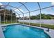 Private screened-in pool with dolphin fountain at 1762 Mincey Ter, North Port, FL 34286