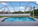 Private screened-in pool with lush surroundings at 1762 Mincey Ter, North Port, FL 34286
