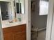 Bathroom featuring tiled floors, a vanity and a view into the walk-in closet at 18094 Ackerman Ave, Port Charlotte, FL 33948