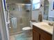 Bathroom featuring tiled floors, a glass shower and a wood vanity at 18094 Ackerman Ave, Port Charlotte, FL 33948