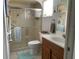 Bathroom featuring tiled floors, a glass shower and a wood vanity at 18094 Ackerman Ave, Port Charlotte, FL 33948