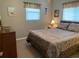 Bedroom featuring neutral walls, carpeted floors and a view into the bathroom at 18094 Ackerman Ave, Port Charlotte, FL 33948