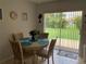 Cozy dining area with a view of the well-maintained backyard and sliding glass door at 18094 Ackerman Ave, Port Charlotte, FL 33948