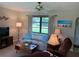 Inviting living room featuring a large window, comfortable sofa, and coordinated decor at 18094 Ackerman Ave, Port Charlotte, FL 33948