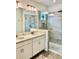 Modern bathroom featuring double sinks, quartz countertops, and glass enclosed shower at 1992 Sunset Preserve Way, Port Charlotte, FL 33953