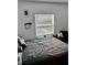 Cozy bedroom with a queen-sized bed, large window, and minimalist decor for a serene atmosphere at 1992 Sunset Preserve Way, Port Charlotte, FL 33953