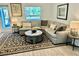 Comfortable living room with a large sectional sofa, stylish rug, and plenty of natural light at 1992 Sunset Preserve Way, Port Charlotte, FL 33953