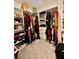 Spacious walk-in closet with custom shelving and ample storage for clothes, shoes, and accessories at 1992 Sunset Preserve Way, Port Charlotte, FL 33953