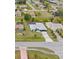 Aerial view highlighting a neighborhood home with a long driveway and meticulous landscaping at 2141 Rio De Janeiro Ave, Punta Gorda, FL 33983