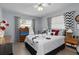 Bedroom with a ceiling fan, two windows, hardwood floors, and an accent chair at 2141 Rio De Janeiro Ave, Punta Gorda, FL 33983