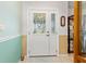 Bright entryway features decorative glass door, neutral tile floor, and fresh paint scheme at 2141 Rio De Janeiro Ave, Punta Gorda, FL 33983