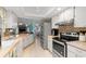 Spacious kitchen featuring stainless steel appliances and an open layout that connects to the living and dining areas at 2141 Rio De Janeiro Ave, Punta Gorda, FL 33983