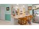 Open concept kitchen with a breakfast bar that flows seamlessly into the outdoor living space and dining area at 2141 Rio De Janeiro Ave, Punta Gorda, FL 33983