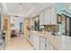 Kitchen boasts tiled countertops, white cabinets, and modern appliances, creating a functional and stylish cooking space at 2141 Rio De Janeiro Ave, Punta Gorda, FL 33983