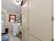 Functional laundry room with tile flooring, utility sink, and ample cabinet space for storage and organization at 2141 Rio De Janeiro Ave, Punta Gorda, FL 33983