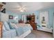 Spacious bedroom features an en-suite bathroom, ceiling fan, and hardwood flooring at 2141 Rio De Janeiro Ave, Punta Gorda, FL 33983