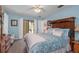 Bright bedroom boasts hardwood flooring, a ceiling fan, and access to the lanai at 2141 Rio De Janeiro Ave, Punta Gorda, FL 33983