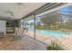 Inviting screened-in pool area with brick pavers, covered patio, and lush green landscaping at 2141 Rio De Janeiro Ave, Punta Gorda, FL 33983