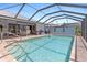 Refreshing pool with brick pavers, surrounded by a screened enclosure, offers a perfect oasis for relaxation and entertainment at 2141 Rio De Janeiro Ave, Punta Gorda, FL 33983