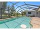 Sparkling pool enclosed by a screened-in lanai, surrounded by lush landscaping and offering a relaxing outdoor space at 2141 Rio De Janeiro Ave, Punta Gorda, FL 33983