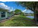Large backyard with patio and water view, perfect for outdoor enjoyment and relaxation at 21539 Gladis Ave, Port Charlotte, FL 33952
