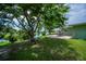 Sprawling backyard featuring a patio, waterfront view, and mature shade trees at 21539 Gladis Ave, Port Charlotte, FL 33952
