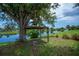 Scenic backyard featuring a large tree, waterfront views, and a custom built tree platform at 21539 Gladis Ave, Port Charlotte, FL 33952