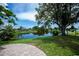 Relaxing water view from the backyard, with mature shade trees and landscaping at 21539 Gladis Ave, Port Charlotte, FL 33952