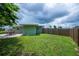 Fenced backyard with patio, lush lawn, and plenty of space at 21539 Gladis Ave, Port Charlotte, FL 33952